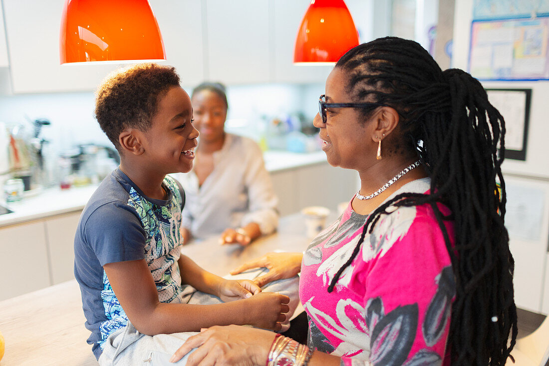 Affectionate grandmother and grandson in kitchen