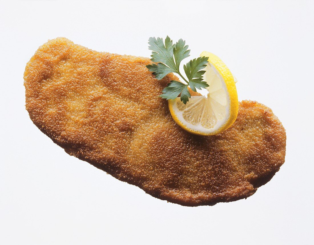 A Wiener Schnitzel with lemon slice and parsley