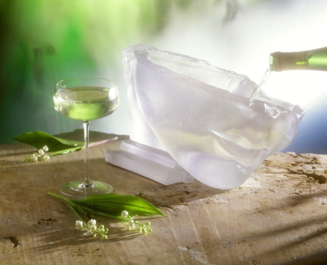 A glass of May wine & champagne is poured into a punchbowl