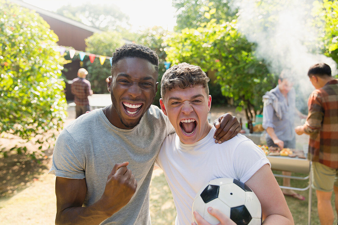 Portrait men with soccer ball cheering