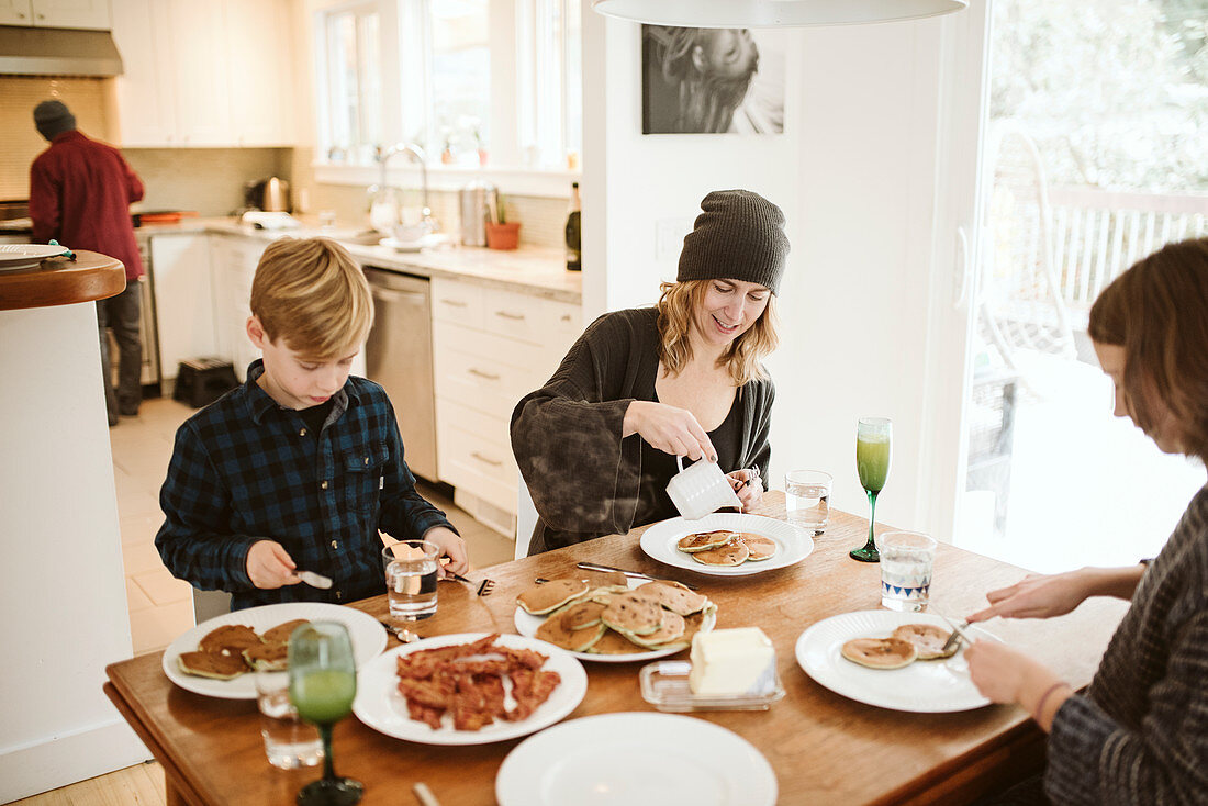 Family eating breakfast at kitchen table
