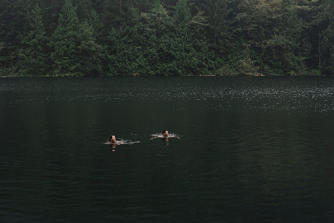 Couple swimming in lake