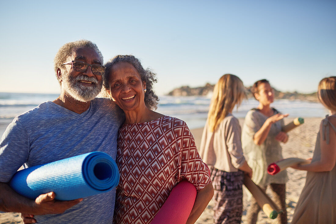 Portrait senior couple with yoga mats