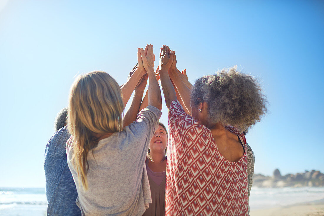 friends raising hands in circle