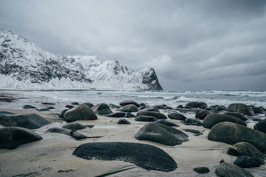 Rocks on snowy, beach, Lofoten Islands, Norway