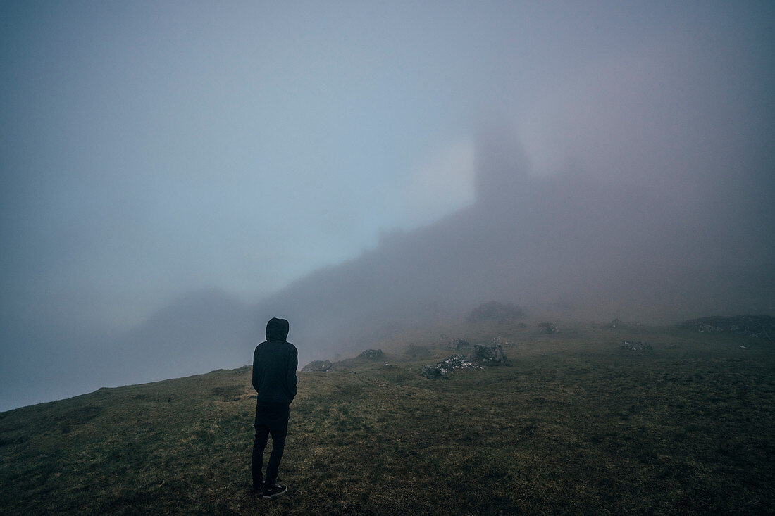 Man standing on foggy, ethereal hill, Isle of Skye, Scotland