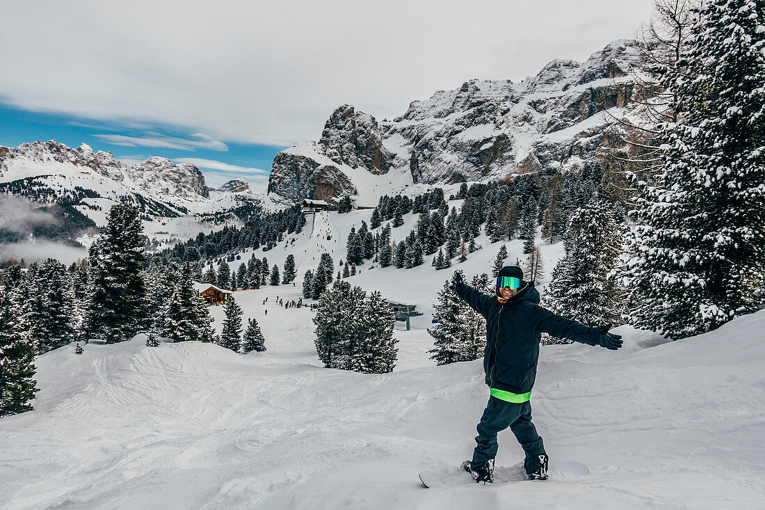 Snowboarder on snowy ski slope, Dolomites, Italy