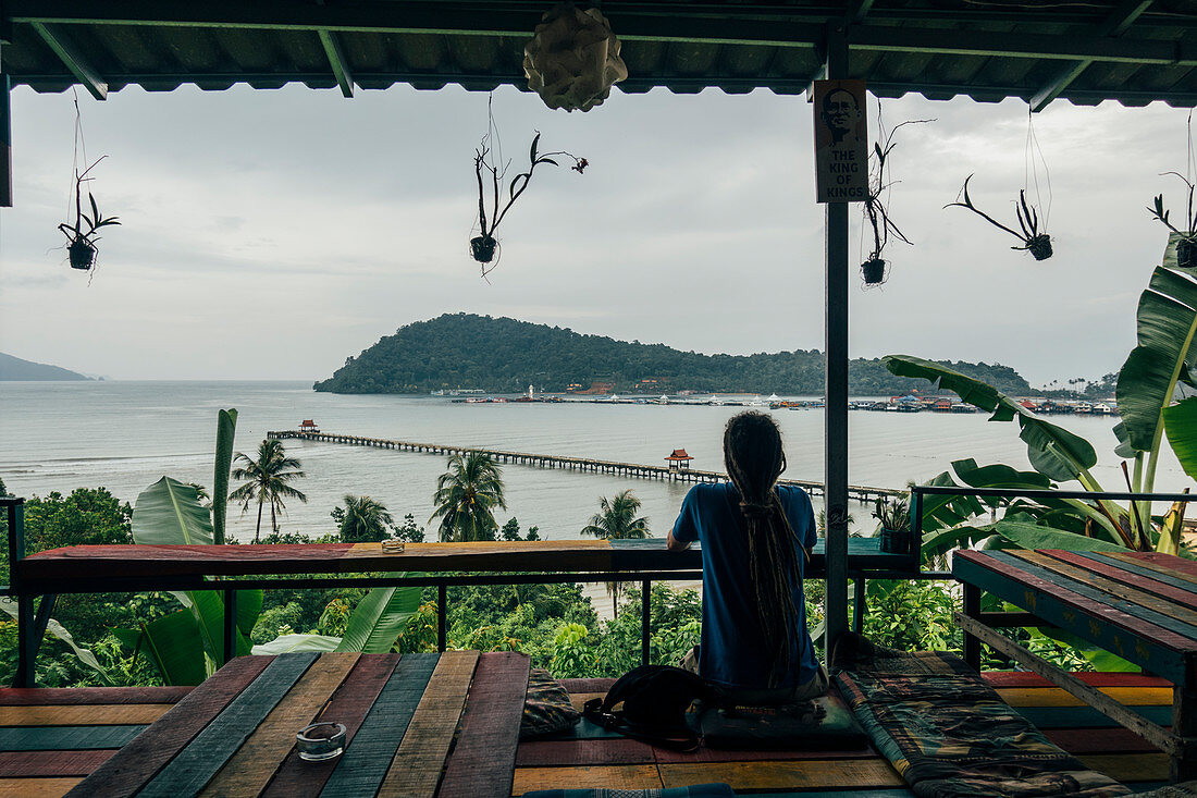 Serene man enjoying ocean view from hut, Koh Chang, Thailand