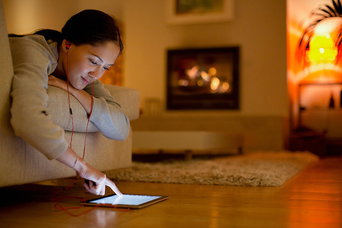 Young woman with headphones using digital tablet