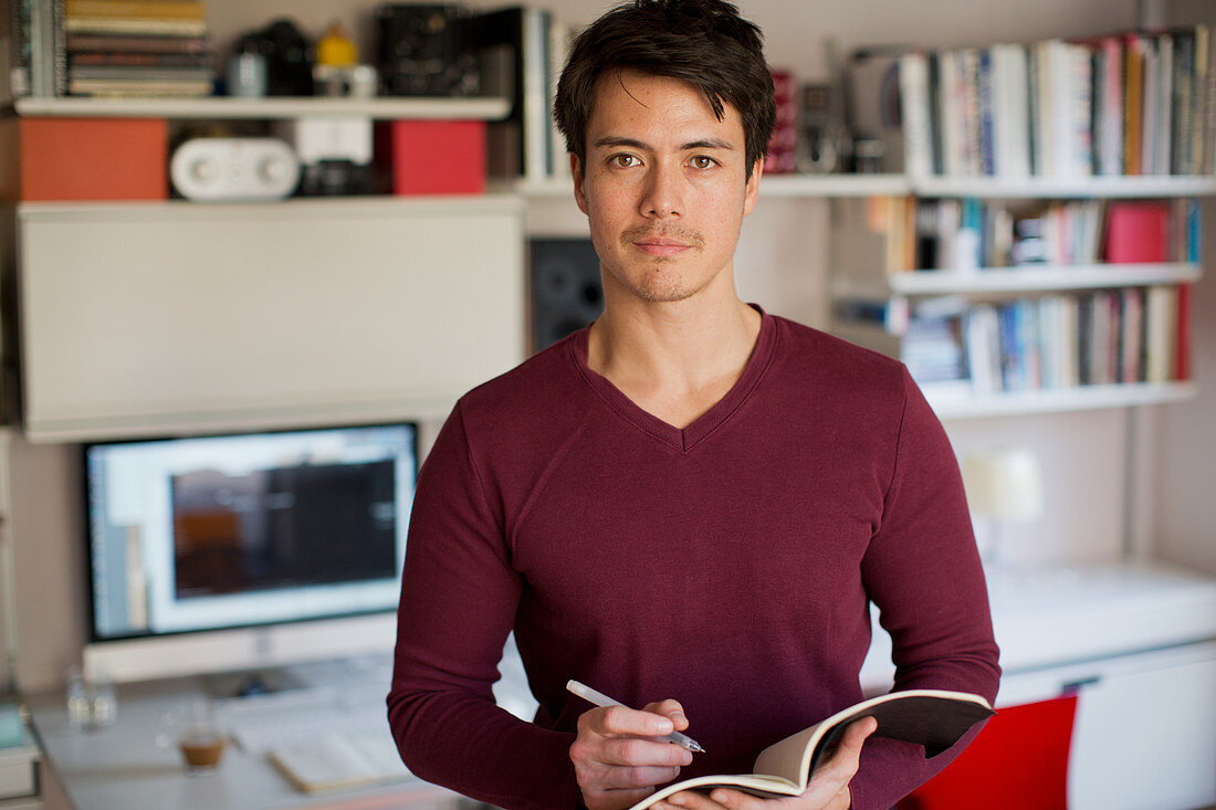 Portrait confident man working in home office