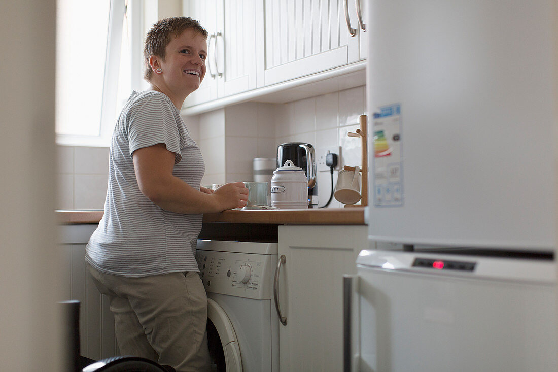 Smiling woman preparing tea