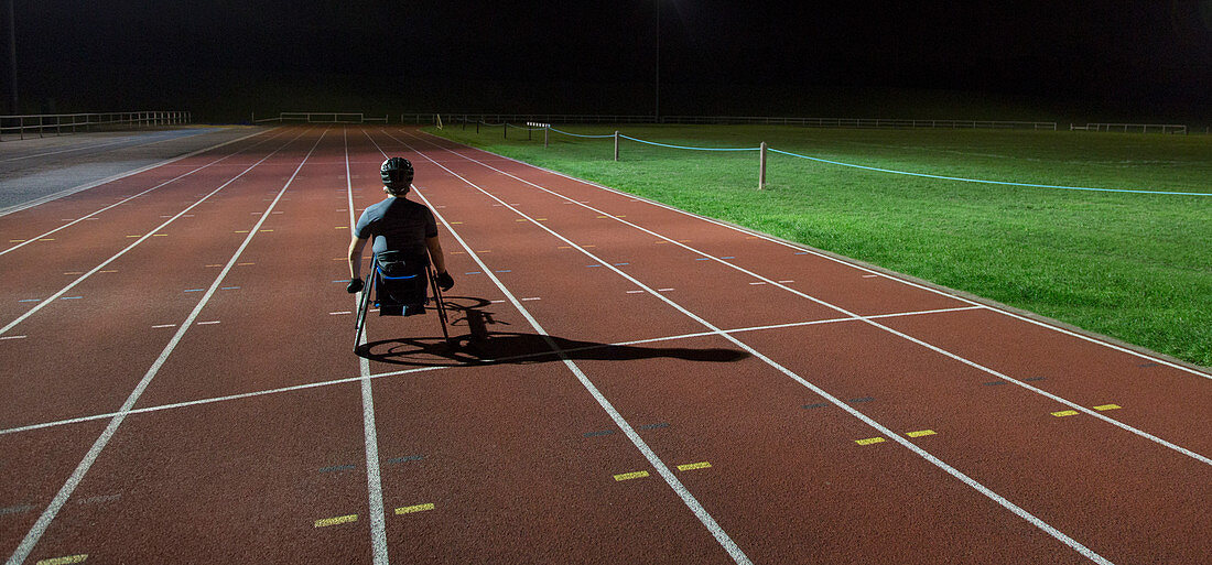 Paraplegic athlete training for wheelchair race at night