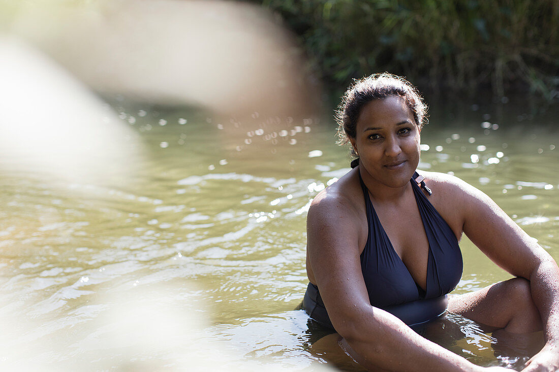 Portrait smiling woman relaxing in river