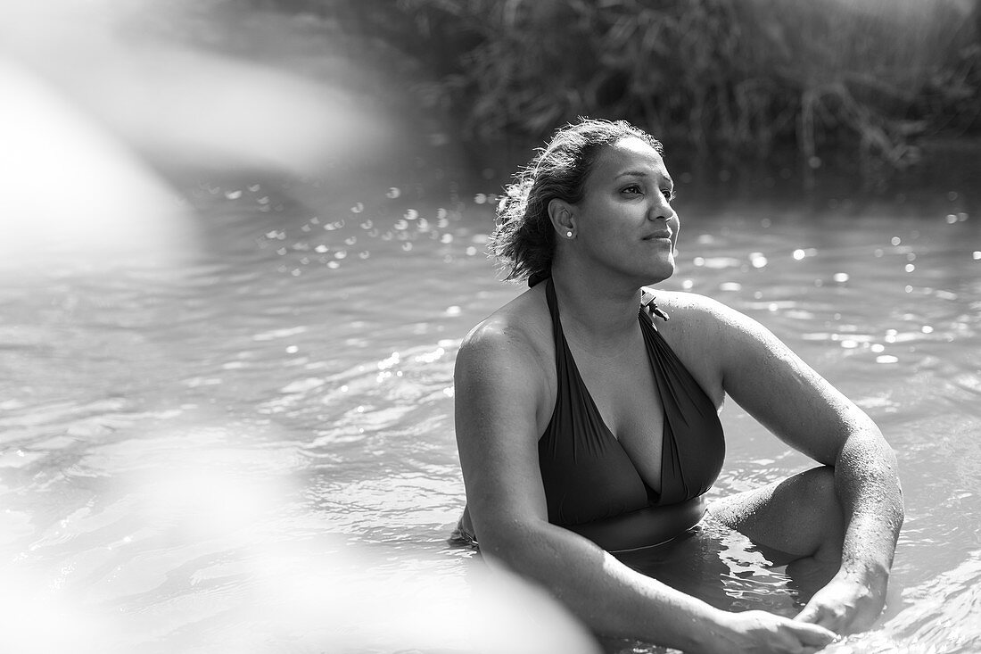 Serene woman sitting in river