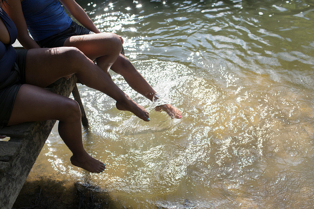 Family splashing legs in river