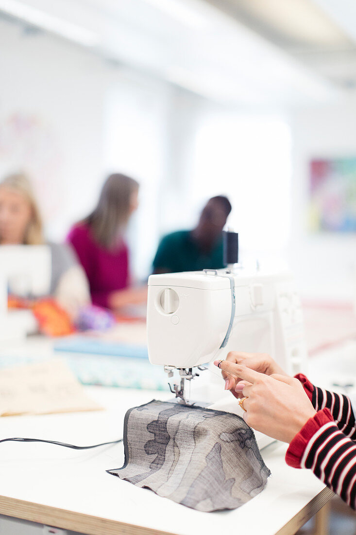 Fashion designer using sewing machine