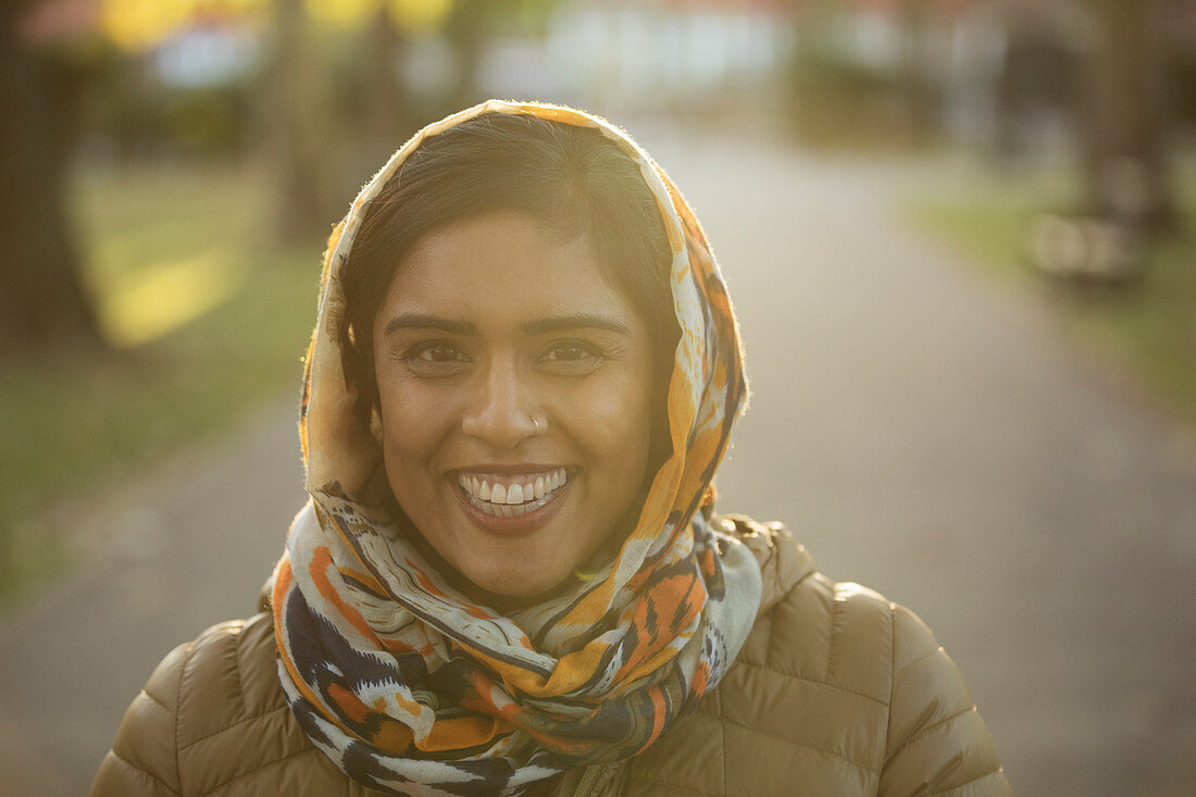 Portrait smiling, Muslim woman wearing hijab in park