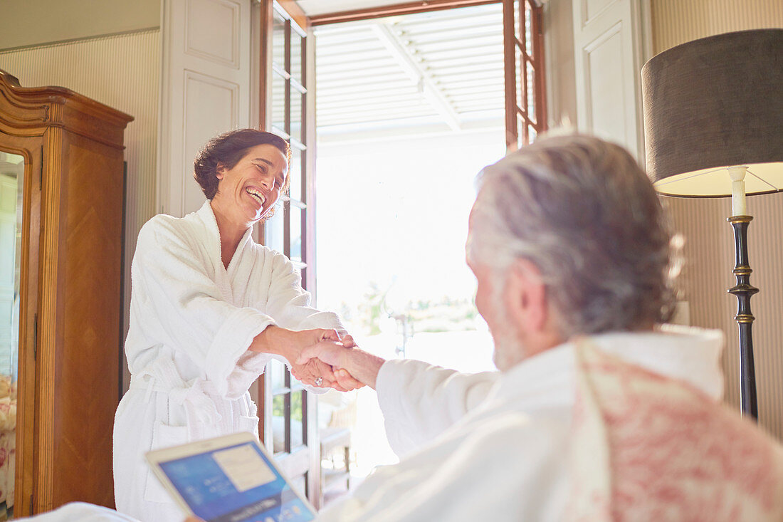 Happy, affectionate couple in bathrobes