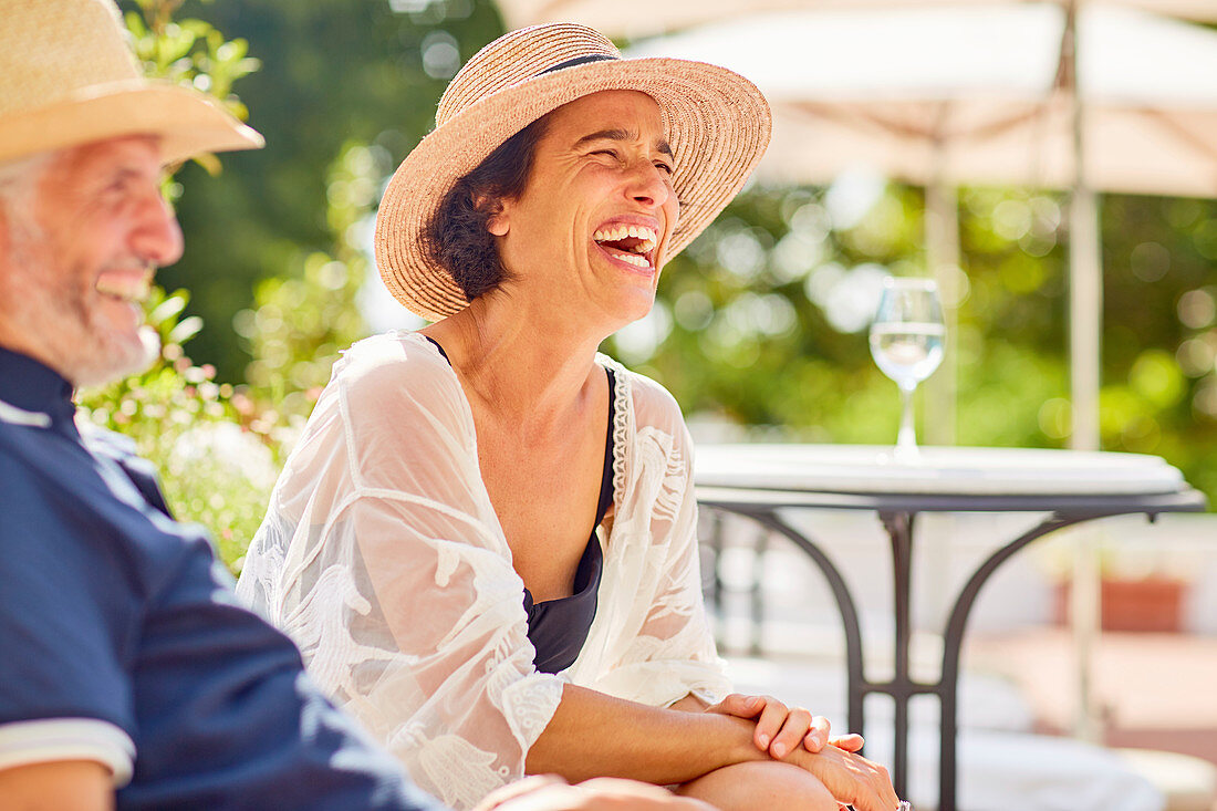 Woman laughing at resort poolside