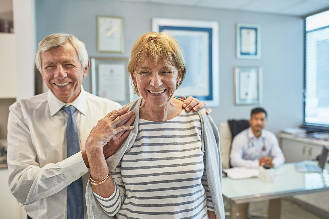 Portrait senior couple leaving clinic doctors office