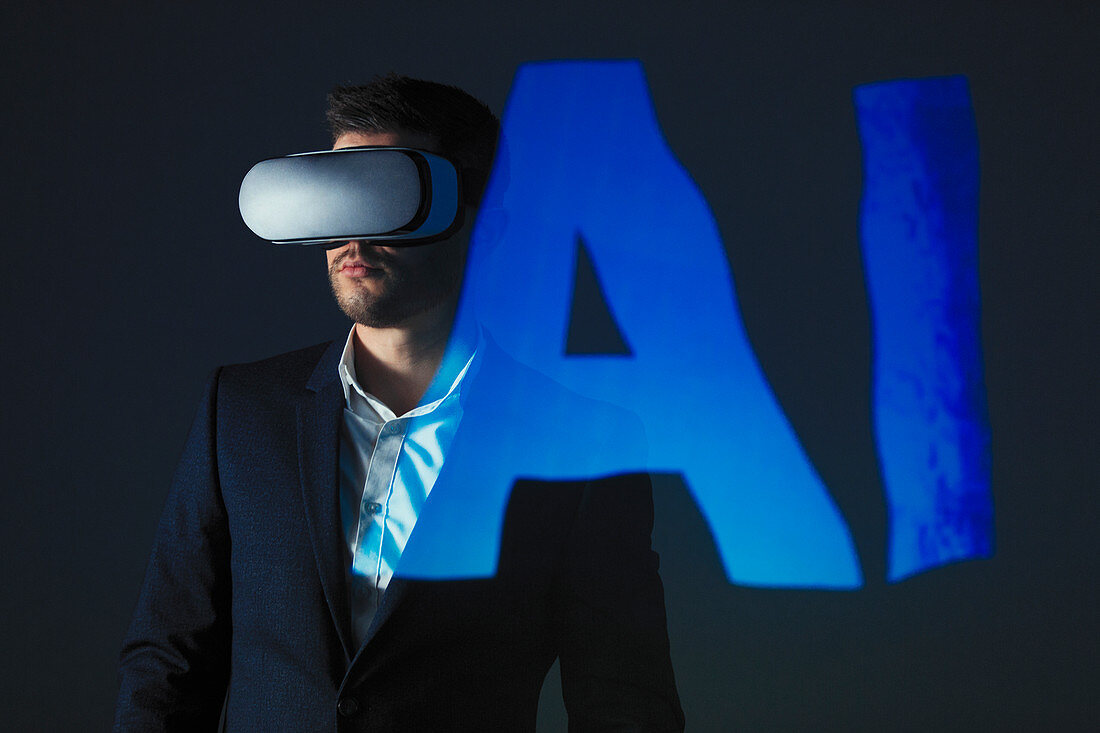 Businessman with VR simulator glasses against AI text