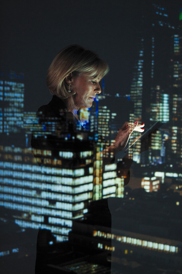 Businesswoman with smart phone at night