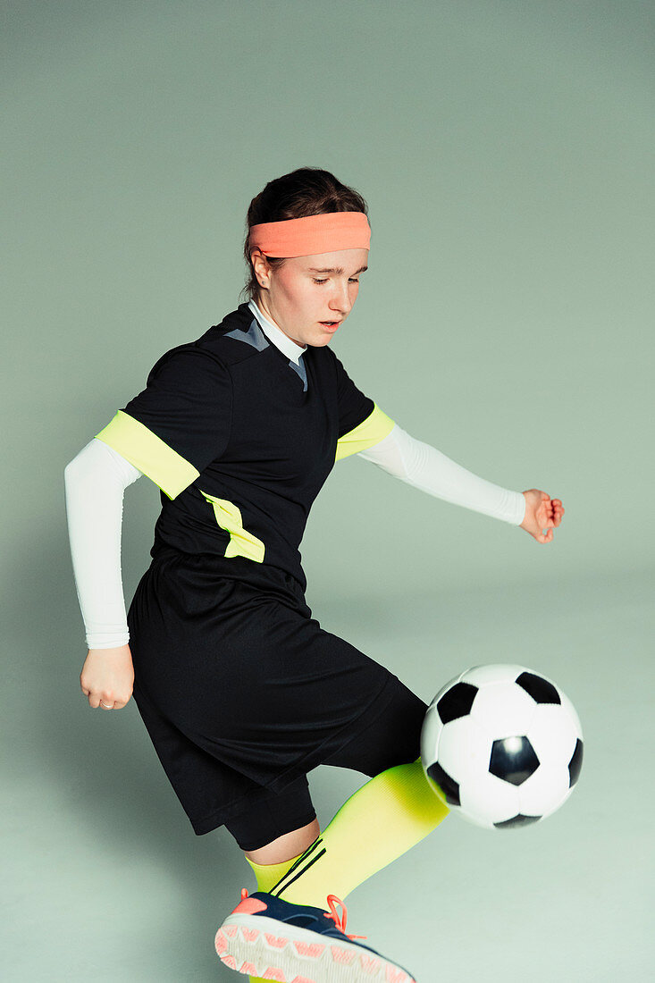 Teenage girl soccer player with soccer ball