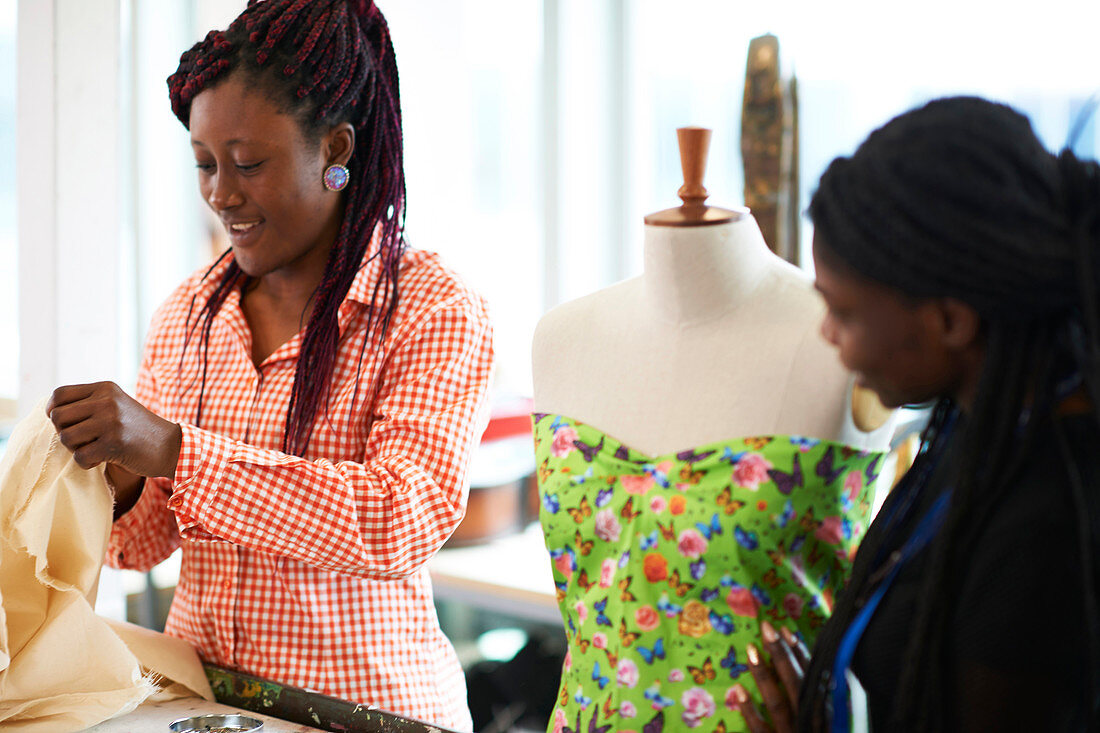 Female fashion designers at dressmakers model in studio