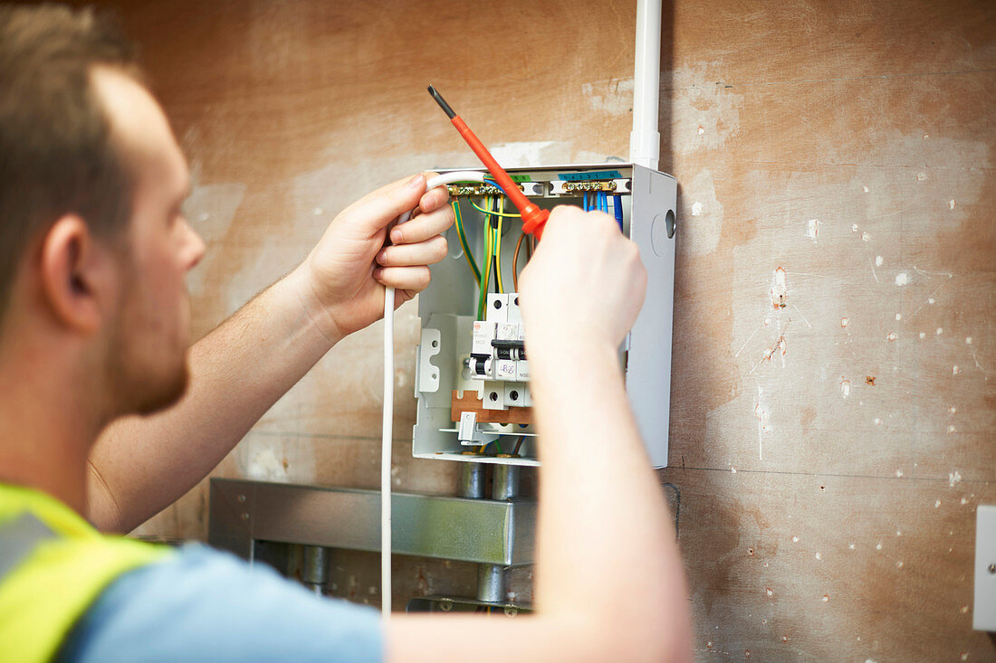 Male electrician student practicing in workshop