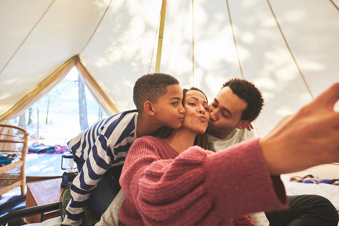 Family taking selfie in camping yurt