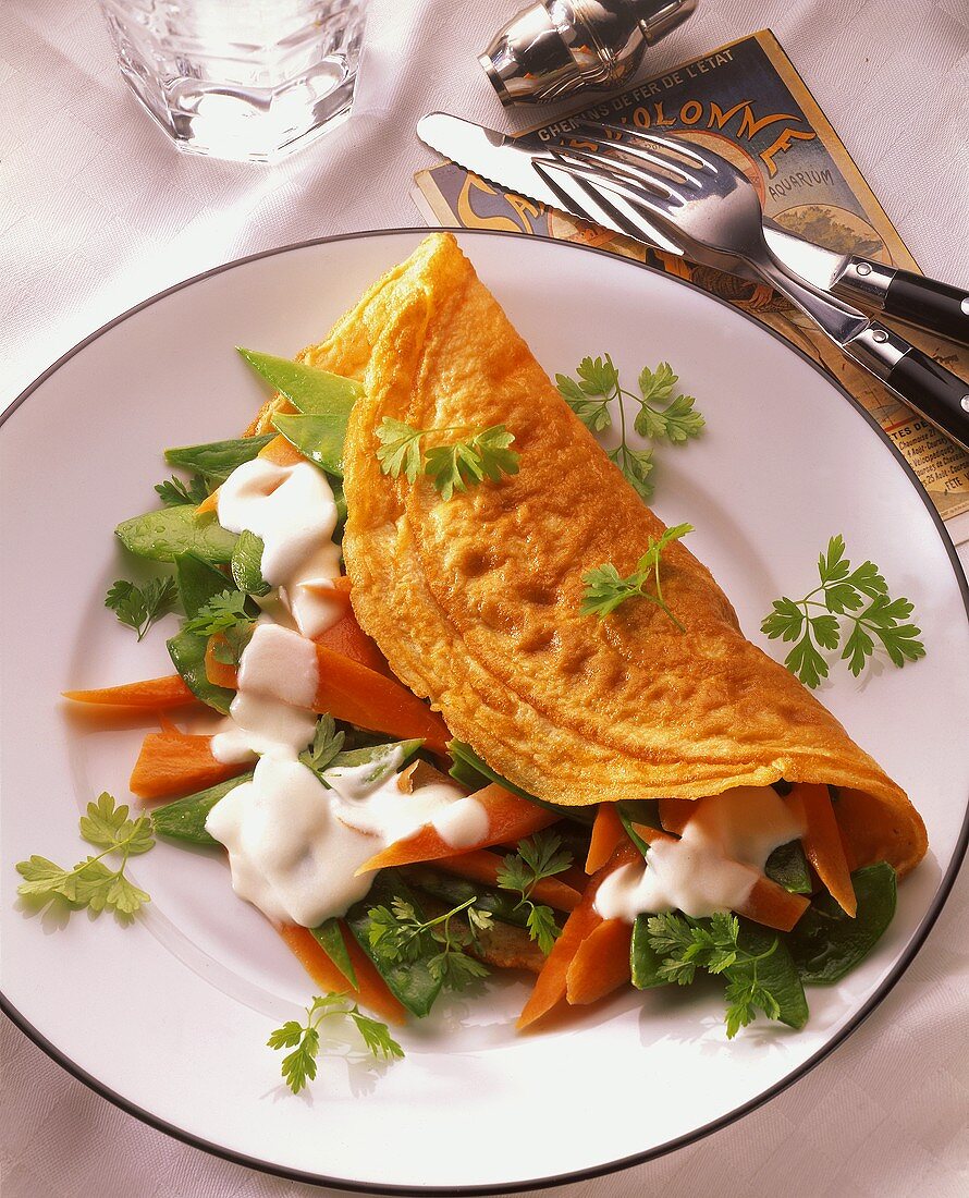 Omelette with carrot & mangetout filling and coriander