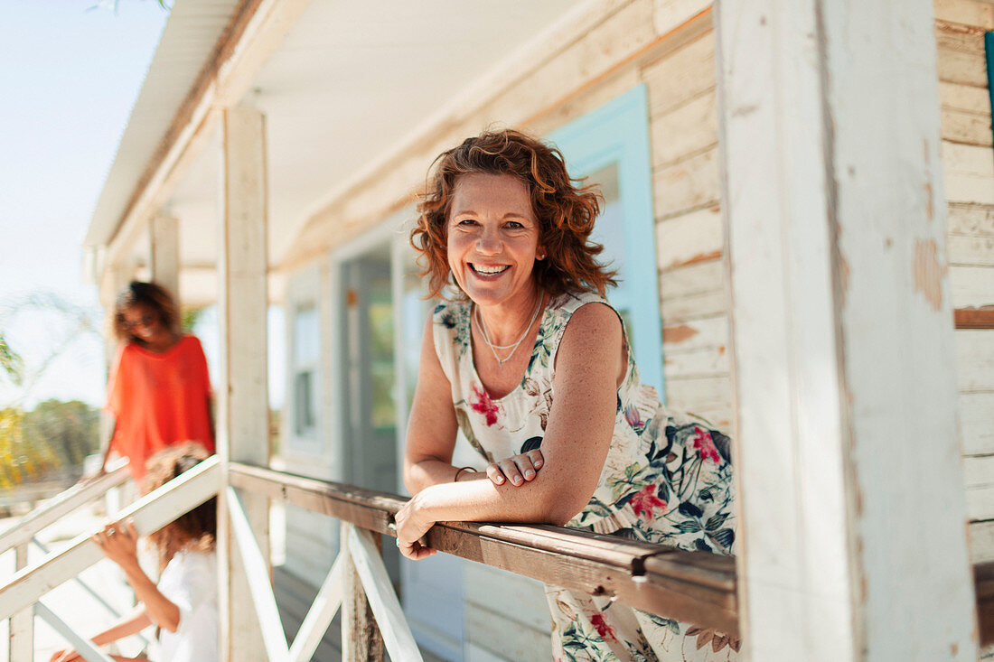 Smiling woman on beach hut patio