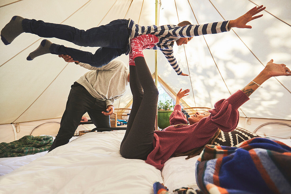 Playful family in camping yurt