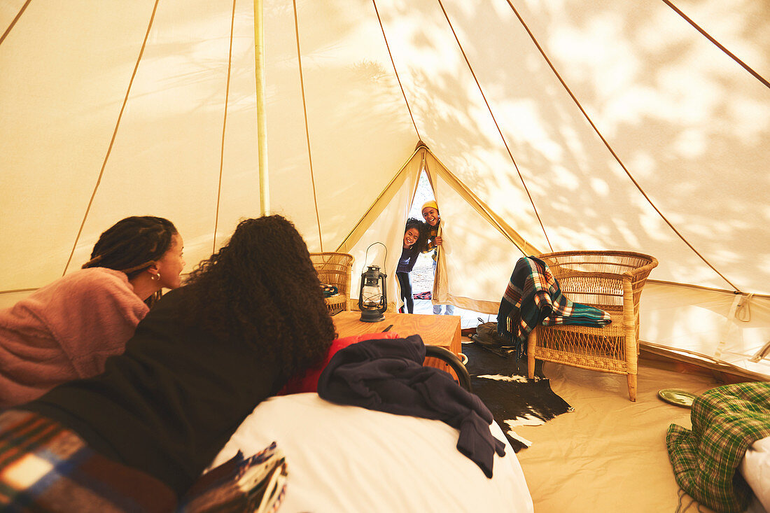Curious kids peeking inside camping yurt