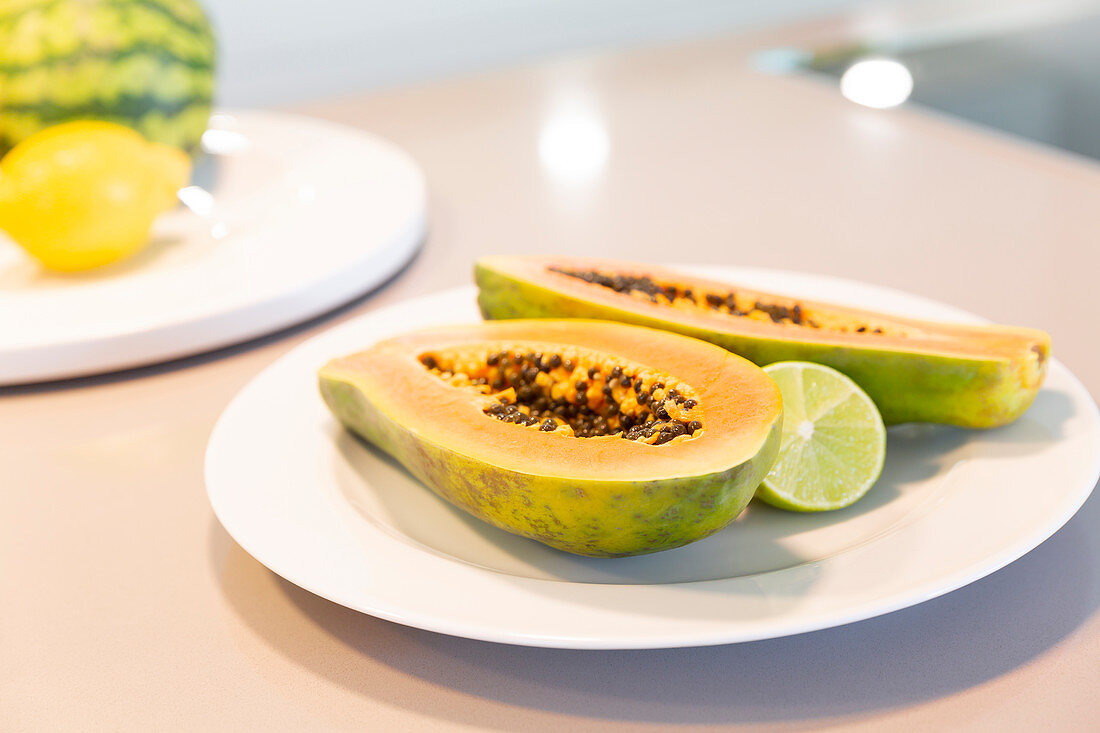 Fresh cut papaya with lime on plate
