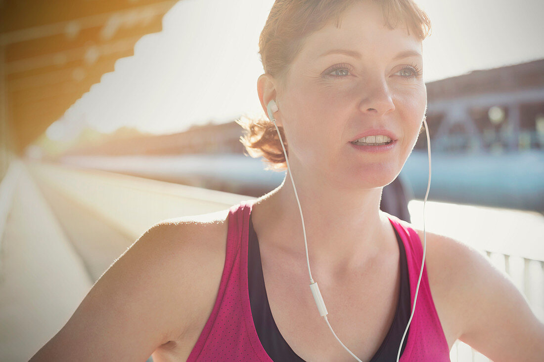 Close up young female runner with headphones