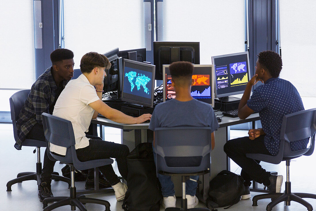 Junior high boy students using computers in computer lab