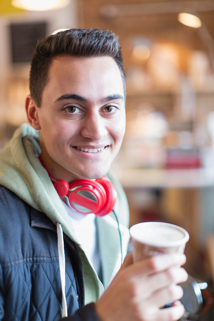 Portrait young man drinking coffee in cafe