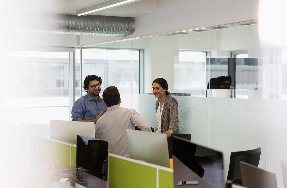 Business people talking, meeting in open plan office