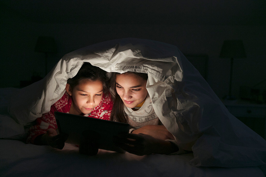 Sisters watching movie on tablet