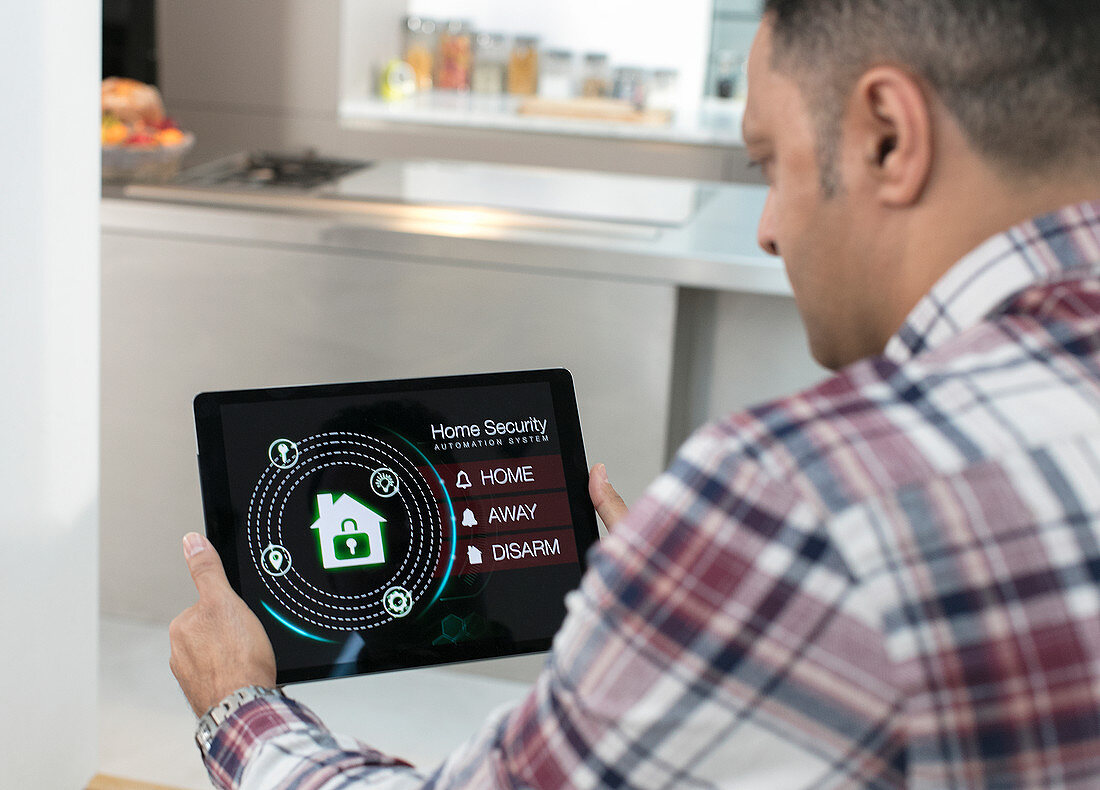 Man setting smart home security alarm from tablet