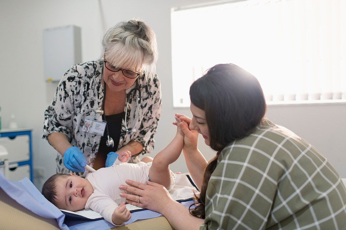 Paediatrician examining baby girl