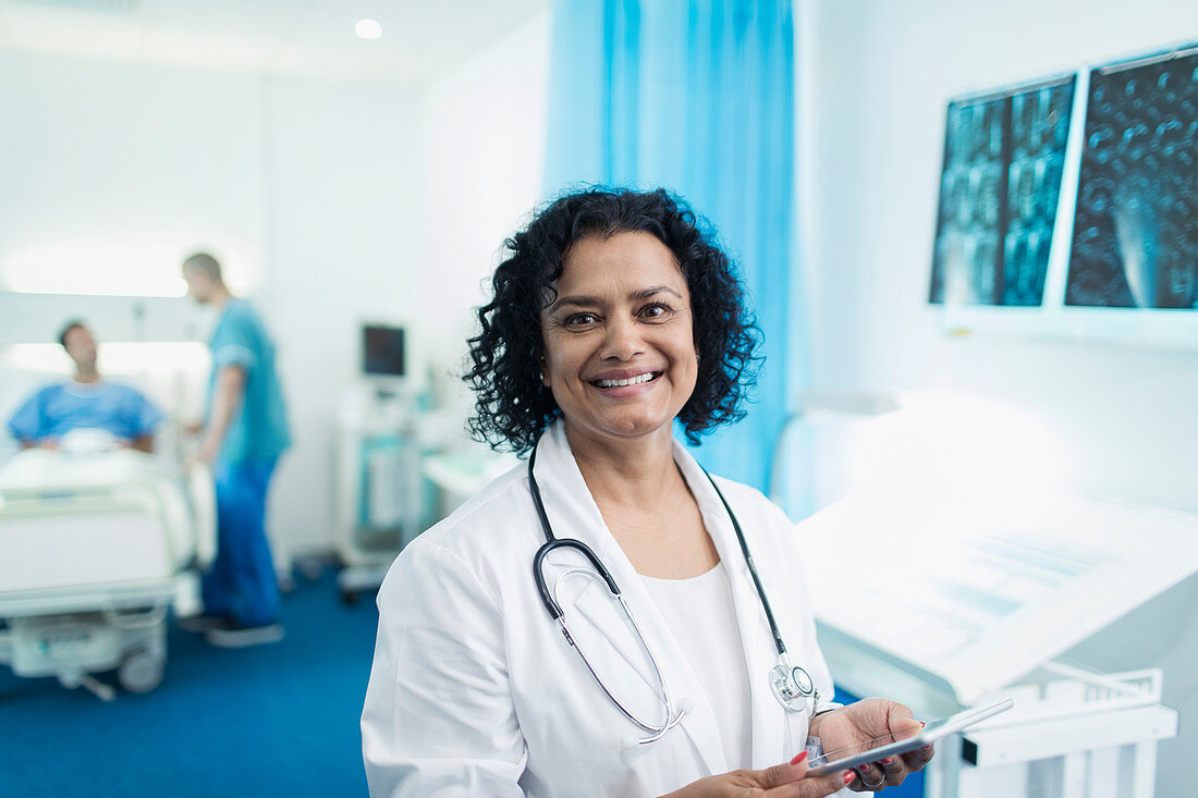 Portrait doctor using digital tablet in hospital room