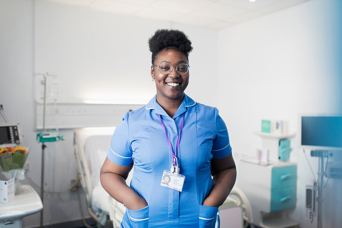 Portrait confident, female nurse in hospital room