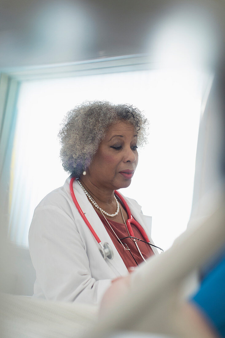 Senior female doctor making rounds in hospital