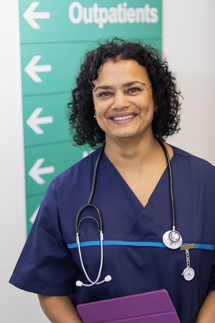 Portrait female doctor in hospital corridor