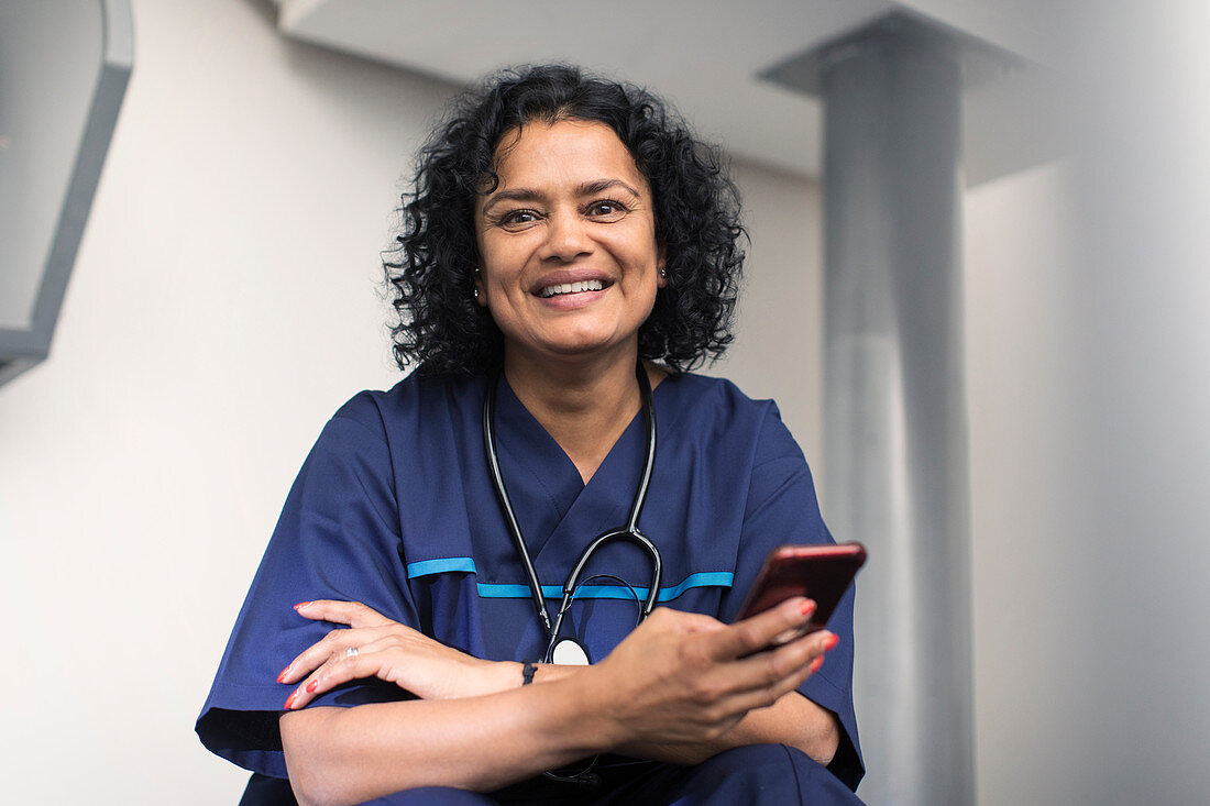 Portrait female doctor using smart phone