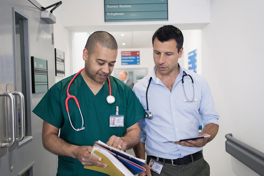 Male doctor and surgeon discussing medical chart