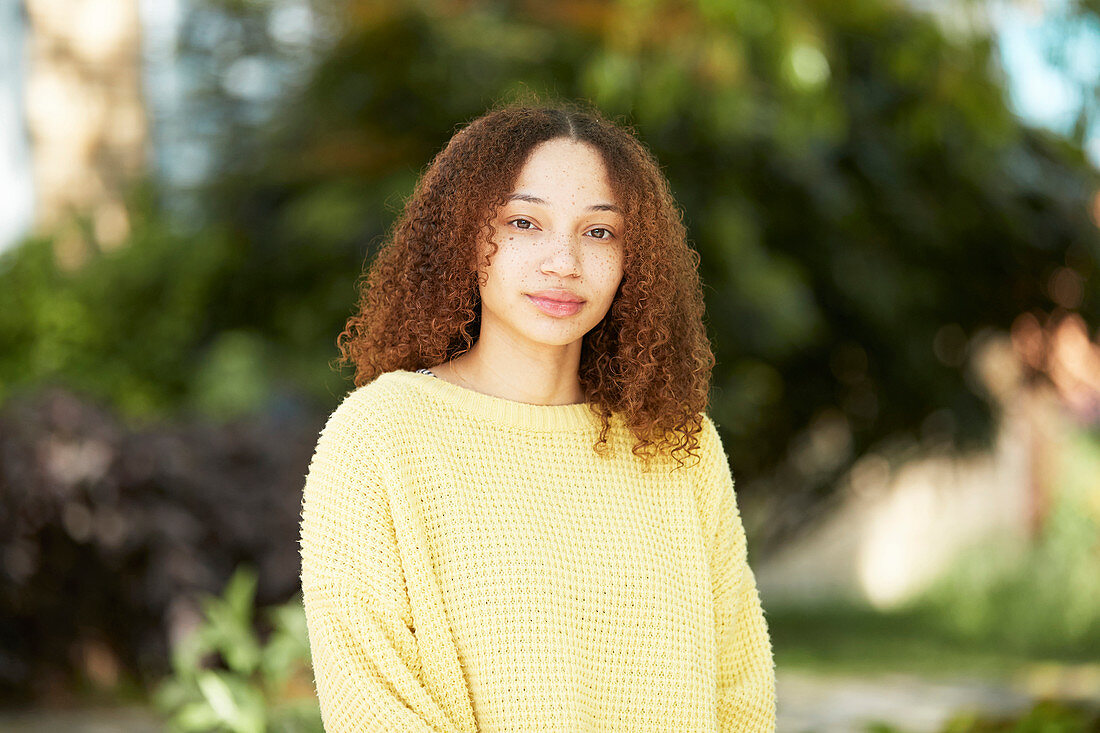 Portrait young woman in yellow sweater