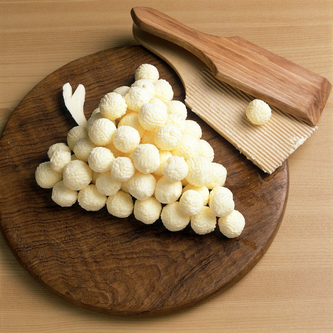 Butter balls on wooden board in shape of bunch of grapes 